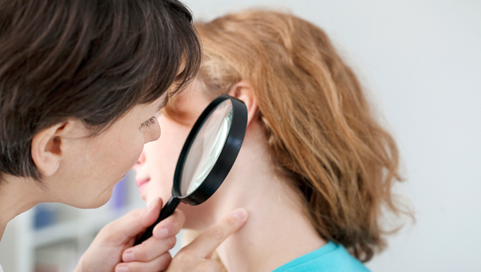 doctor checking lump behind ear