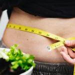 fat woman measuring waist